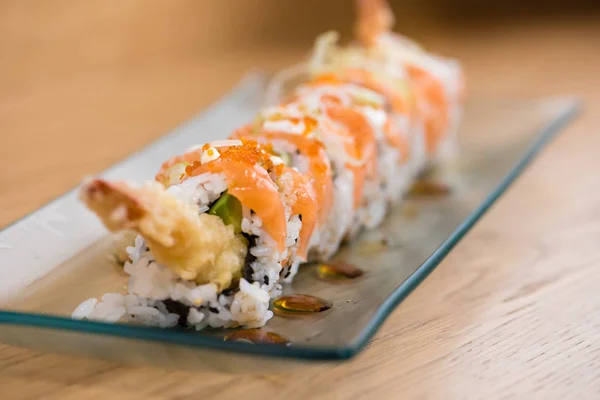 special rice roll with shrimp tempura, avocado, salad, red onion