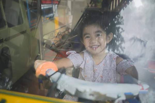 child learns to drive on tuk-tuk taxi