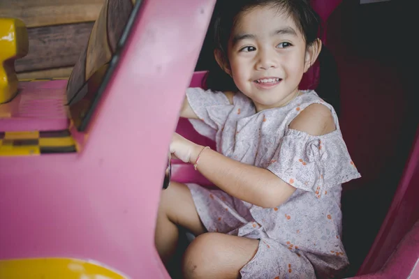 child learns to drive the toy car