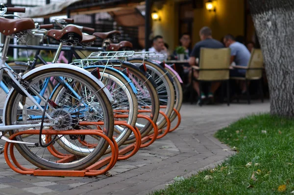 row of parked bicycles near restaurant