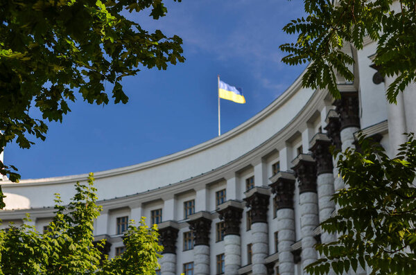 Cabinet of Ministers of Ukraine in selective focus on branches trees