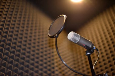Sound recording room with noise insulation. Microphone with pop filter. clipart