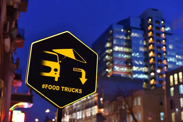 sign of food trucks in downtown nigh