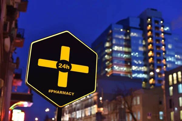 sign of Pharmacy 24 hours on night street