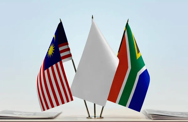 Malaysia Republic of South Africa flags on stand with papers
