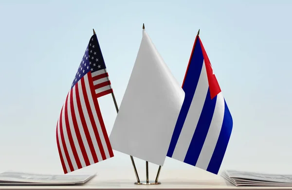 USA and Cuba flags on stand with papers