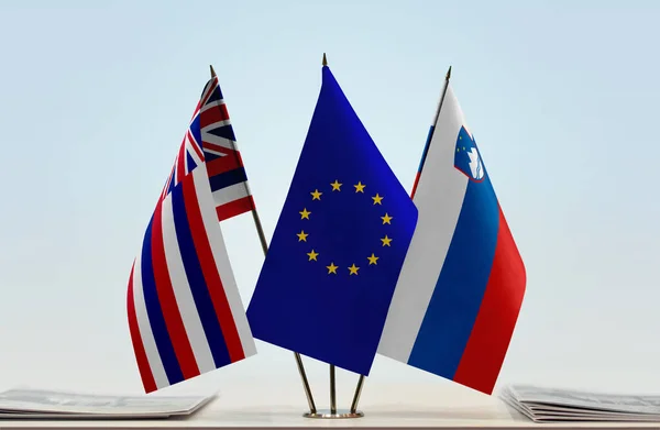 stock image Hawaii Slovenia and eu flag on stand with papers