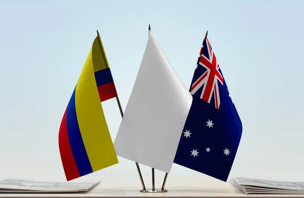 Colombia Australia flags on stand with papers