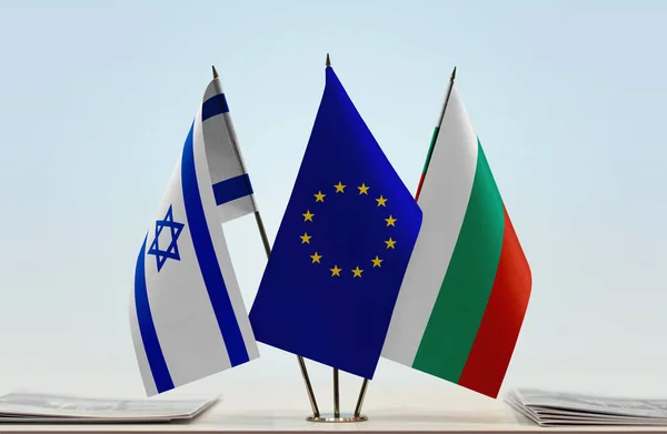 Israel, Bulgaria and eu flags on stand with papers