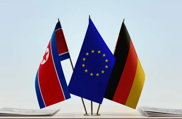 North Korea Germany and eu flag on stand with papers