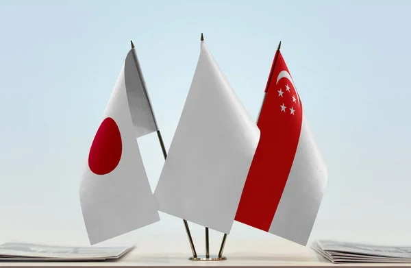 Japan Singapore White Flags Stand Newspapers Table — Stock Photo, Image