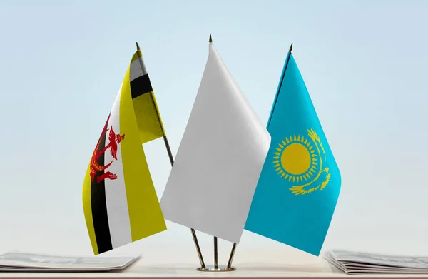 Kasachstan Und Brunei Flaggen Auf Stand Mit Papieren — Stockfoto