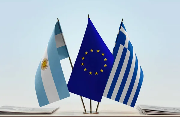 Argentina and eu flags on stand with papers