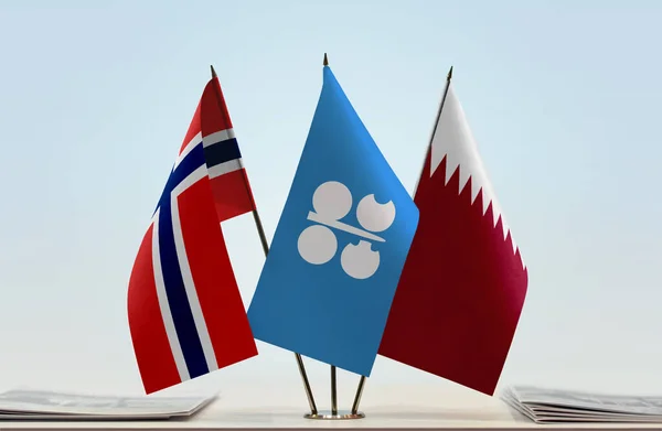 Qatar and Norway flags on stand with papers