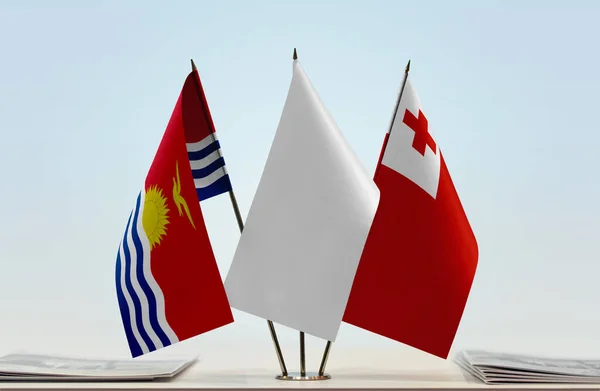 Kiribati Tonga and white flags on stand with papers