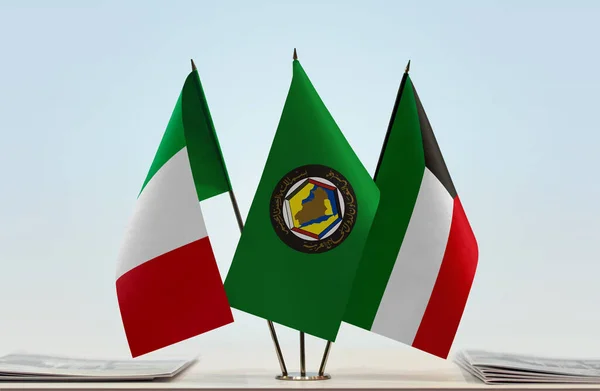 Italy , Kuwait flags on stand with papers