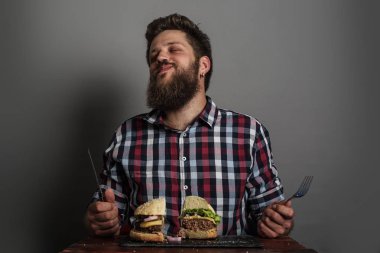 Man eating fresh self made burger close up clipart