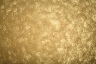Parlayan ışıkların, partinin, bayramın, Noel 'in soyut altın rengi arka planı