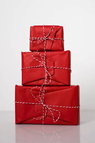 Christmas Gift Boxes Wrapped Red Paper Bow Dtriped Rope White — Stock Photo, Image