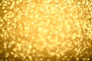 Parlayan ışıkların, partinin, bayramın, Noel 'in soyut altın rengi arka planı