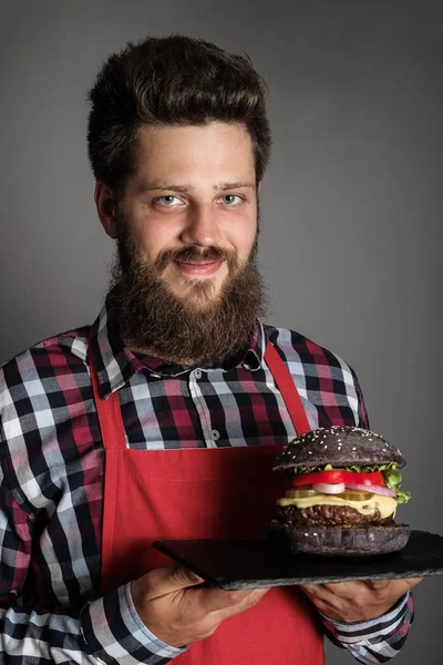 Cook with black burger — Stock Photo, Image