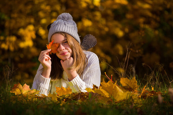 Portrait of pretty nice teenage girl in autumn park , background with copy space for text