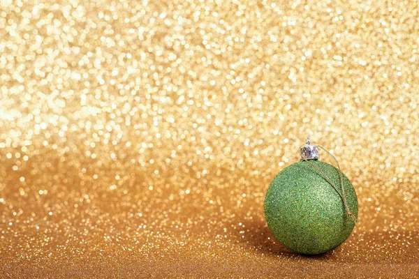Christmas ball on gold glitters