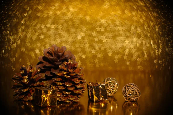 Pine cones on golden background — Stock Photo, Image