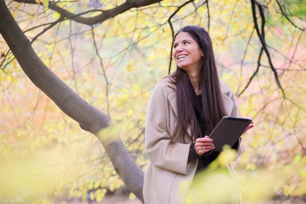 Smiling Young Woman Using Digital Tablet Sitting Autumn Park — Stock Photo, Image