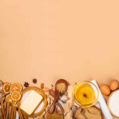 Noel kurabiyeleri arka planda düz görünüm şablonu ve metin için fotokopi alanı oluşturuyordu. Kahverengi kağıt zemin üzerinde kap kacak, baharat ve yiyecek malzemeleri.