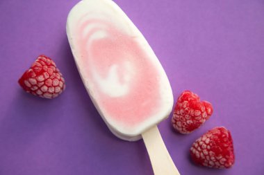 Meyvenin sorbe ve yoğurt ile mor bir arka plan üzerinde ahududu buzlu şeker