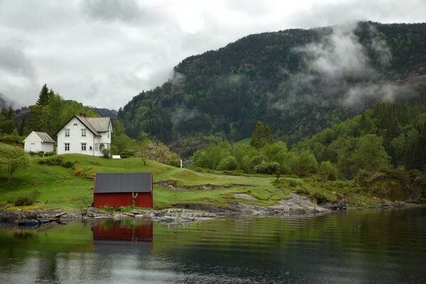 Low cloud clinging to the mountainside in the fjord near Bergen in Norway