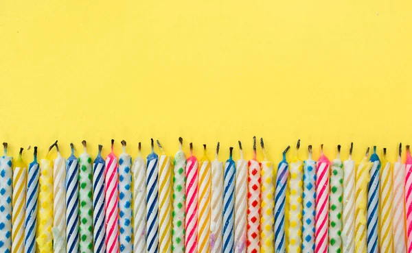 Velas Quemadas Sobre Fondo Amarillo —  Fotos de Stock