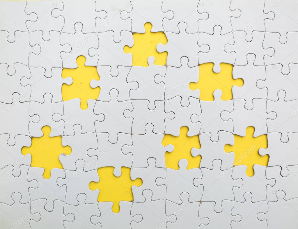 Missing few white  puzzle pieces on yellow background
