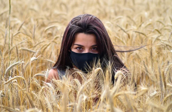 a beautiful girl in a field of golden spikes in freedom