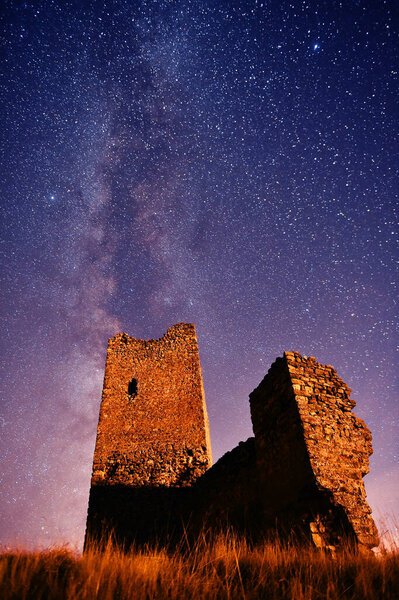 a castle with the milky way in the background