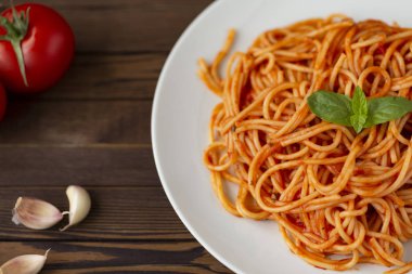 Tabak makarna salça ve koyu ahşap arka plan üzerinde üstten görünüm yemek pişirmek için malzemeler