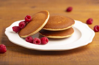 Ahududu ve ahşap zemin üzerine nane ile küçük gözleme