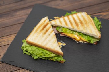 Lezzetli kahvaltı. İştah açıcı sandviç salam, peynir ve domates ile