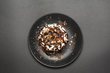 Beze tatlısı Pavlova pasta siyah arka plan üzerine çikolata şurubu ile