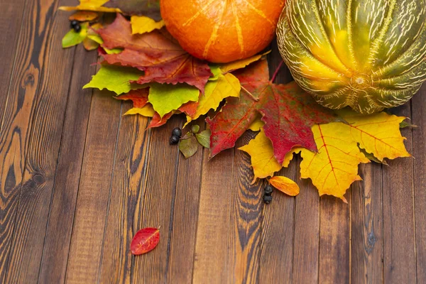 Thanksgiving background. Autumn vegetables, berries and leaves on a wooden Board. The concept of thanksgiving.