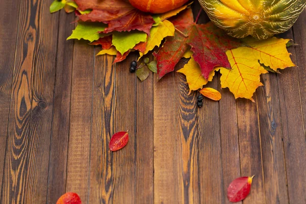 Thanksgiving background. Autumn vegetables, berries and leaves on a wooden Board. The concept of thanksgiving.