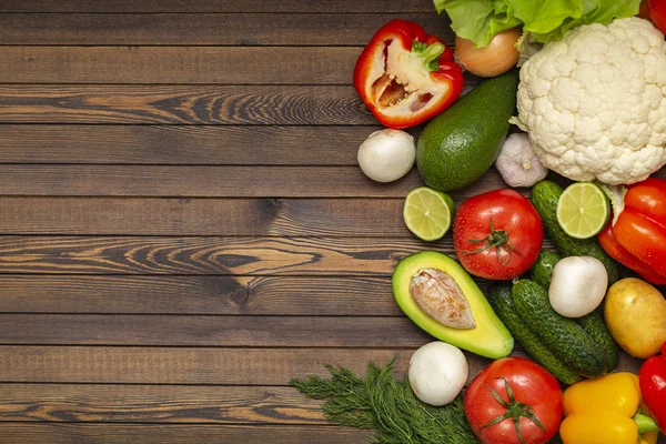 Flat lay composition with assortment of fresh vegetables on wooden table. Fresh farmers garden vegetables on wooden table. Diet concept. Space for text