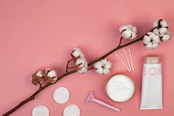 The concept of skin care. Cotton pads for removal makeup, cotton branch, cotton pads, ear sticks, pink towel. Flat lay background Top view copy space