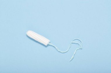 Pamuk tampon mavi zemin üzerine. Adet dönemi kavramı. Kadın hijyen koruma. Üstten Görünüm, düz yatıyordu.