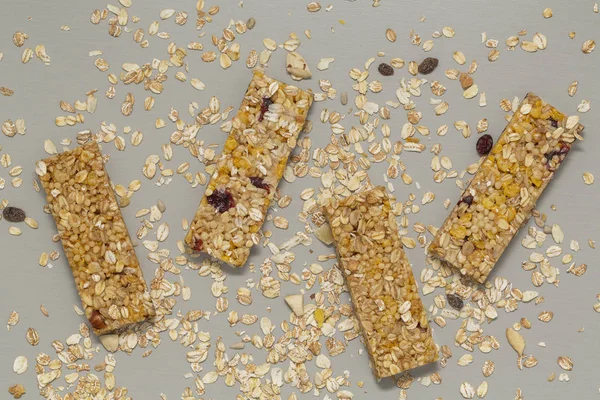 Granola bar. Cereal granola bar with nuts, fruit and berries on a gray stone table. Healthy sweet dessert snack. Vegan food. Top view.