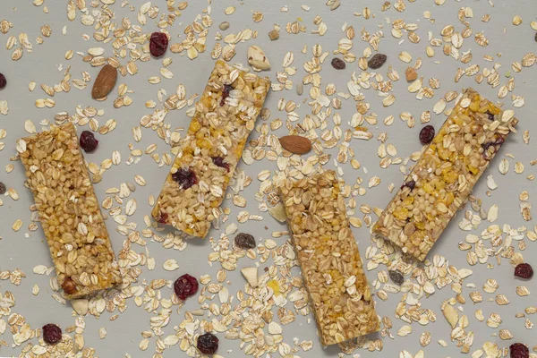 Granola bar. Cereal granola bar with nuts, fruit and berries on a gray stone table. Healthy sweet dessert snack. Vegan food. Top view.