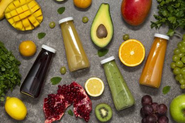 Renkli tatlılar taze tropikal meyve ve sebze beton zemin, üstten görünüm üzerine şişelerde. Düz yatıyordu. Sağlıklı, temiz yemek, vegan, vejetaryen, Detoks, diyet gıda kavramı.