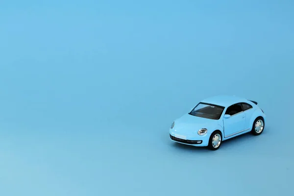 Blue retro toy model car on blue background. VW Beetle in Blue Die cast model on a blue background.