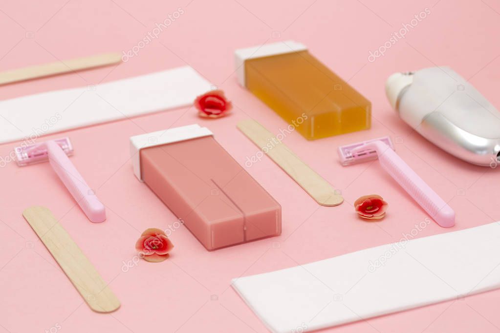 Set for epilation on pink background. The concept of hair removal. Flat lay. 